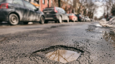 Pothole in street. Image from Adobe Stock.