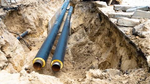 Water main lines in a ground trench for repair