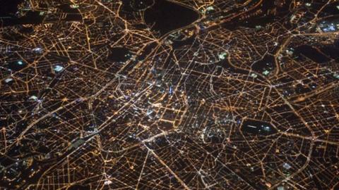 Aerial photo of a city at night lit up from space