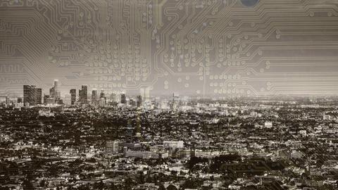 Metropolish skyline with a translucent overlay of a computer chip