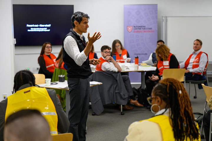Dr. Balsari addressing a room of participants at tables