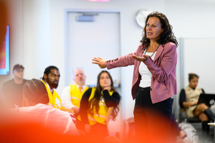 Juliette Kayyem addressing a room with attendees watching attentively