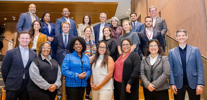 Diverse group of mayors and staff posing on stairs
