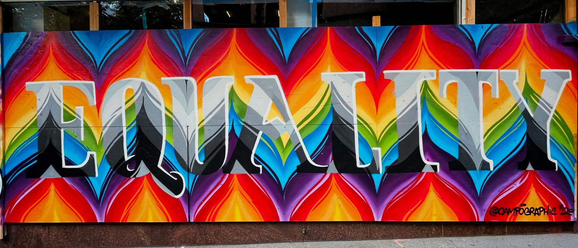 Rainbow graffiti that says "equality"