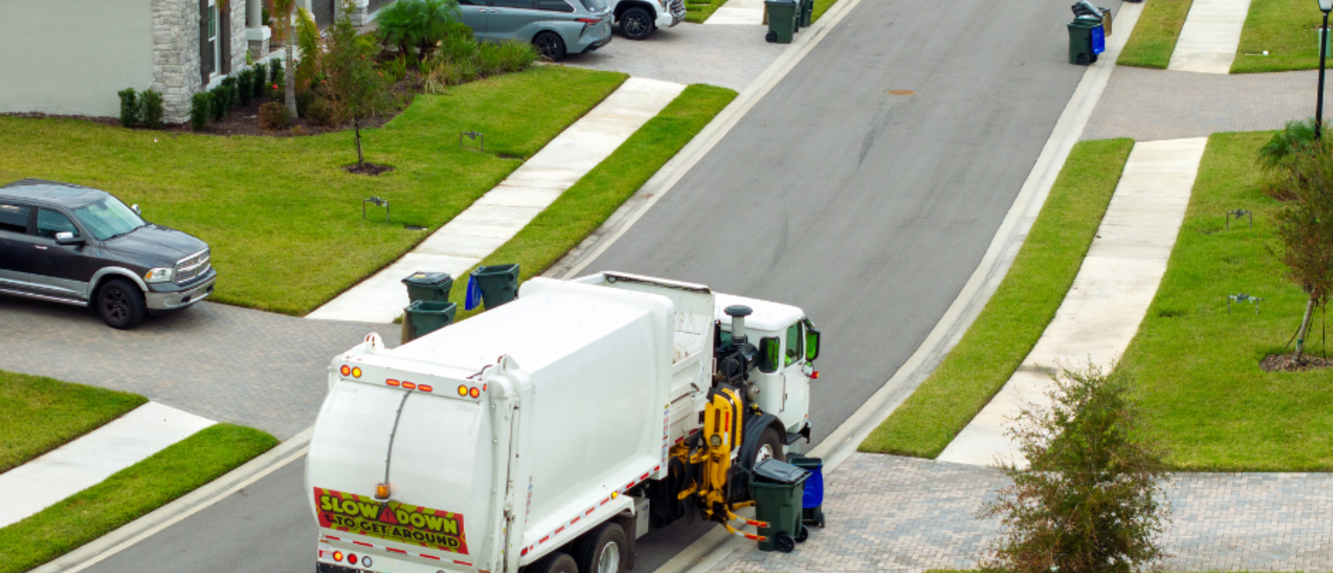 Garbarge truck picking up trash bins on the street