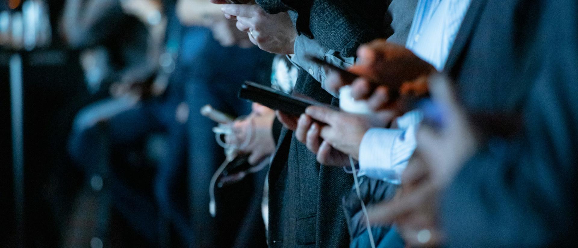 Stylized photo of a crowd of people using smartphones
