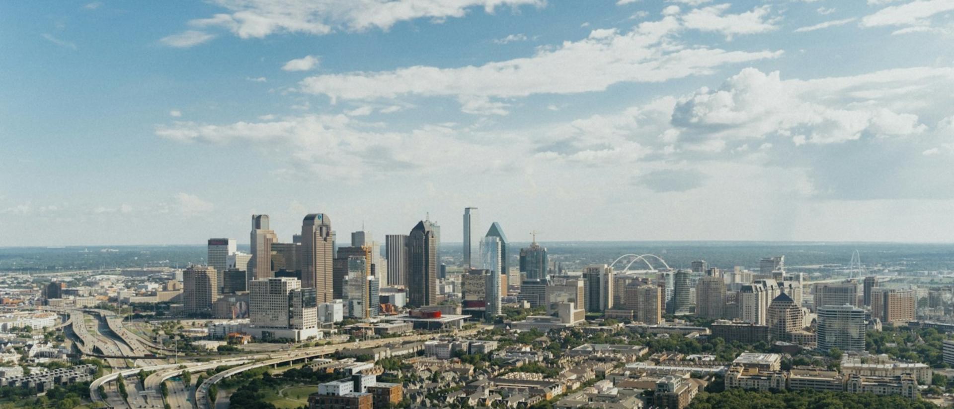 City skyline from a distance with sunny skies