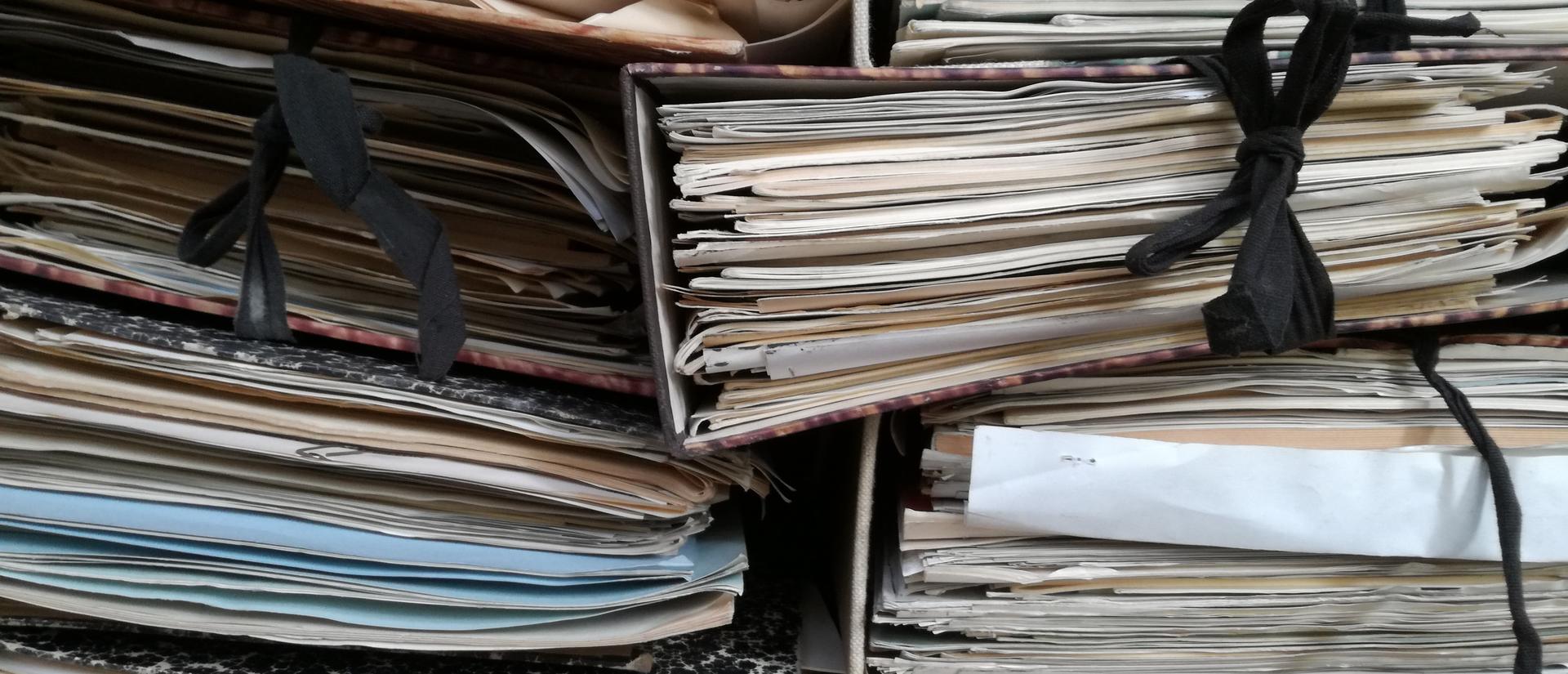 Papers and books stacked together