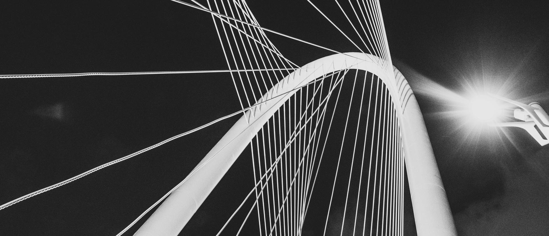 Stylized black and white bridge, looking up 