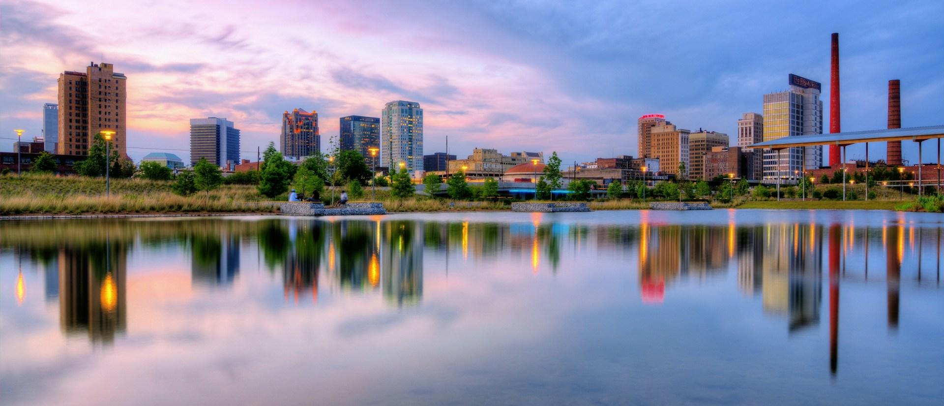 City skyline at sunset with reflection in water