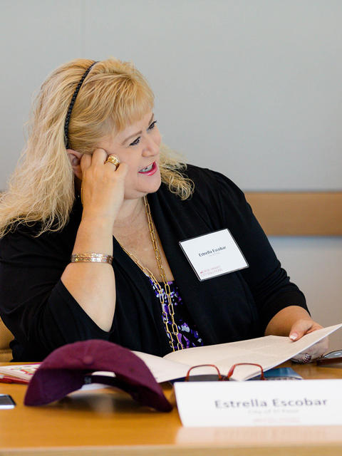 Estrella Escobar at a table during a PMI event